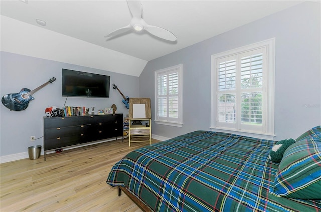 1570 Oakford Rd, Sarasota, FL 34240 - bedroom featuring wood finished floors, baseboards, vaulted ceiling, and a ceiling fan
