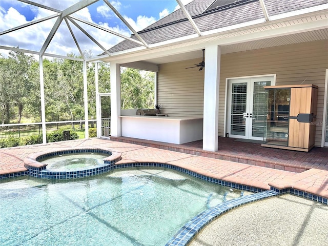 1570 Oakford Rd, Sarasota, FL 34240 - view of swimming pool featuring a pool with connected hot tub, a patio, glass enclosure, a ceiling fan, and french doors