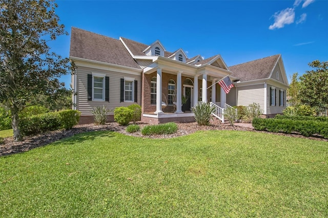 1570 Oakford Rd, Sarasota, FL 34240 - greek revival house with a porch, a front yard, and a shingled roof