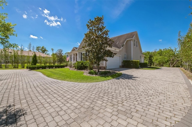 1570 Oakford Rd, Sarasota, FL 34240 - view of property exterior with decorative driveway, a yard, and an attached garage