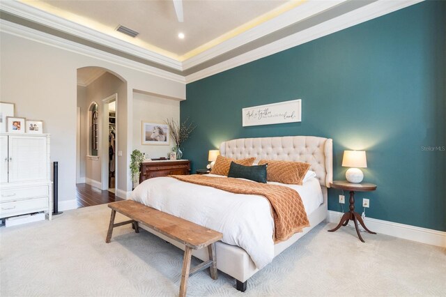 1570 Oakford Rd, Sarasota, FL 34240 - carpeted bedroom with arched walkways, ornamental molding, baseboards, a walk in closet, and recessed lighting