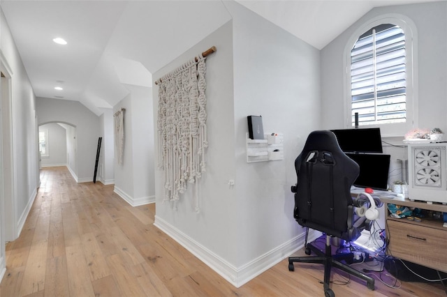1570 Oakford Rd, Sarasota, FL 34240 - home office with lofted ceiling, arched walkways, plenty of natural light, light wood-style floors, and baseboards
