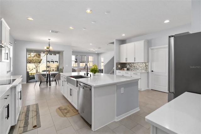 3121 Buffington Pl, Oviedo, FL 32765 - kitchen with a sink, stainless steel appliances, a chandelier, a center island with sink, and white cabinets