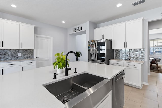 3121 Buffington Pl, Oviedo, FL 32765 - kitchen featuring stainless steel appliances, a sink, tasteful backsplash, recessed lighting, and light countertops