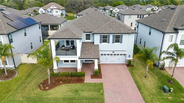 3121 Buffington Pl, Oviedo, FL 32765 - view of front facade with a residential view, stucco siding, decorative driveway, a garage, and a balcony
