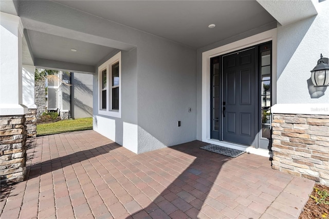 3121 Buffington Pl, Oviedo, FL 32765 - property entrance featuring stucco siding, stone siding, and a porch