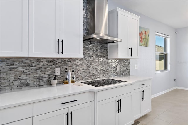 3121 Buffington Pl, Oviedo, FL 32765 - kitchen featuring wall chimney range hood, black electric cooktop, decorative backsplash, and baseboards