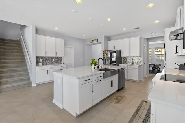3121 Buffington Pl, Oviedo, FL 32765 - kitchen featuring a sink, appliances with stainless steel finishes, tasteful backsplash, a kitchen island with sink, and recessed lighting
