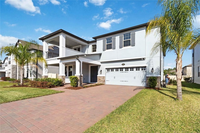 3121 Buffington Pl, Oviedo, FL 32765 - view of front of property featuring stucco siding, decorative driveway, an attached garage, a front lawn, and stone siding