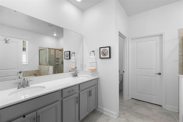 5052 Blanchard Ct, Saint Cloud, FL 34772 - full bath featuring double vanity, a stall shower, baseboards, and a sink