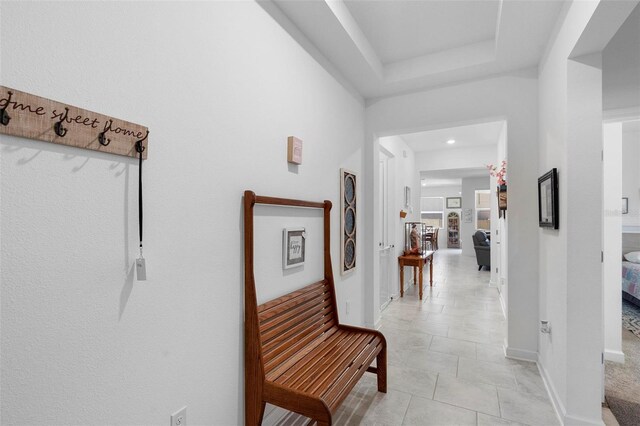 5052 Blanchard Ct, Saint Cloud, FL 34772 - hallway featuring baseboards, a raised ceiling, and light tile patterned flooring
