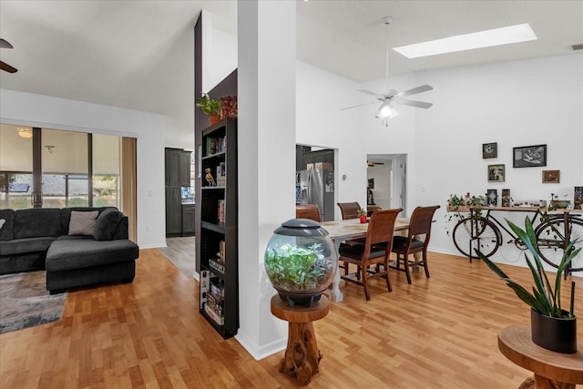 10400 Hunters Trail Ct, Orlando, FL 32817 - living area with light wood finished floors, visible vents, ceiling fan, a skylight, and a high ceiling