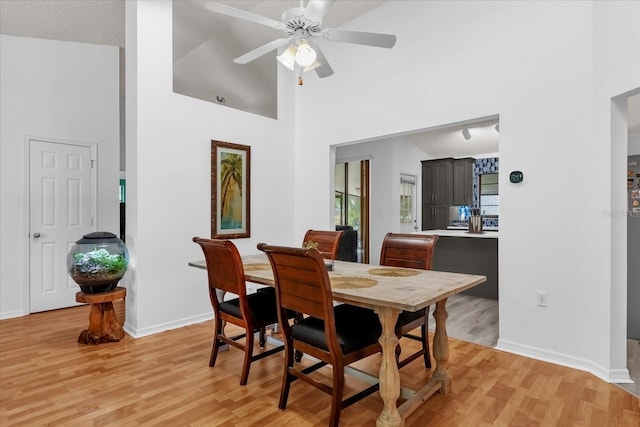 10400 Hunters Trail Ct, Orlando, FL 32817 - dining space featuring a high ceiling, baseboards, light wood-type flooring, and ceiling fan