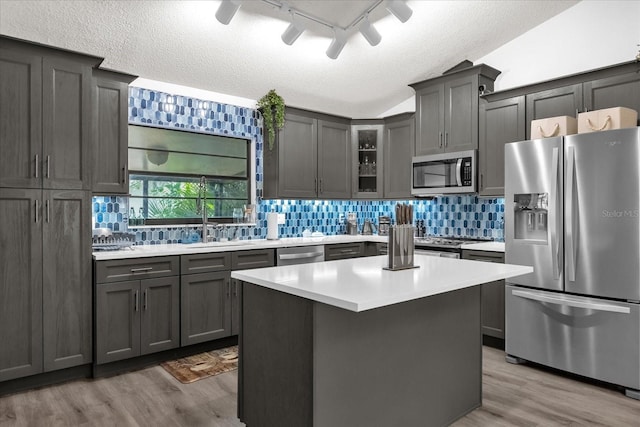 10400 Hunters Trail Ct, Orlando, FL 32817 - kitchen with tasteful backsplash, appliances with stainless steel finishes, light countertops, and wood finished floors