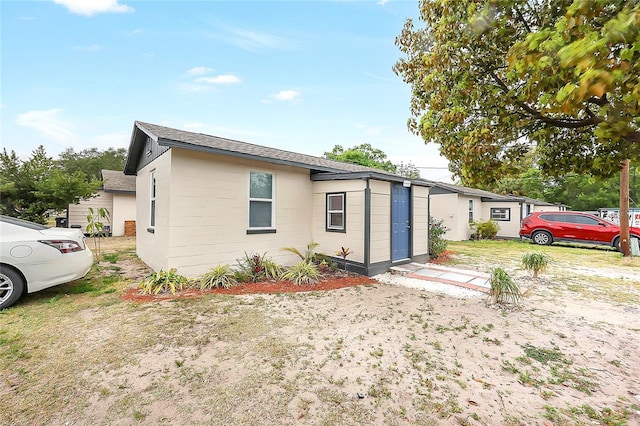 626 Marvin C Zanders Ave, Apopka, FL 32703 - exterior space with concrete block siding and a shingled roof