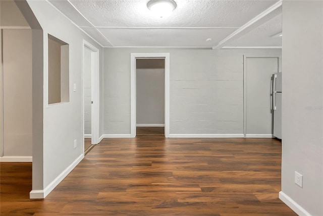 626 Marvin C Zanders Ave, Apopka, FL 32703 - empty room with concrete block wall, wood finished floors, baseboards, and a textured ceiling