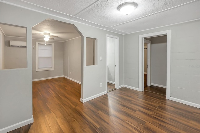 626 Marvin C Zanders Ave, Apopka, FL 32703 - empty room with a textured ceiling, an AC wall unit, ceiling fan, and wood finished floors