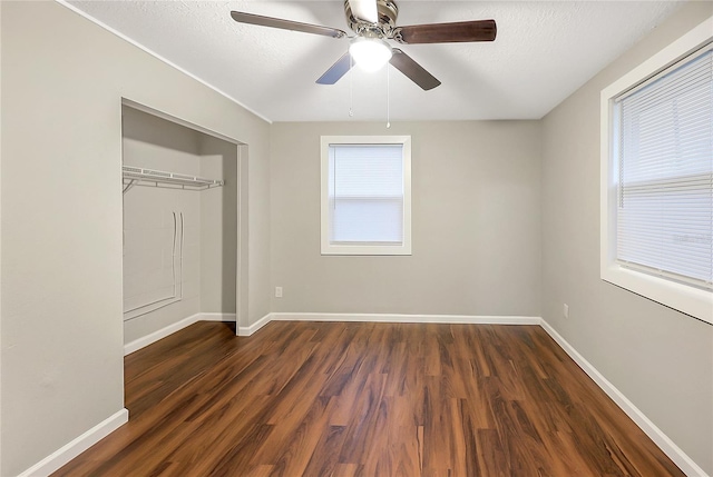 626 Marvin C Zanders Ave, Apopka, FL 32703 - unfurnished bedroom with a textured ceiling, a closet, baseboards, ceiling fan, and dark wood-style flooring