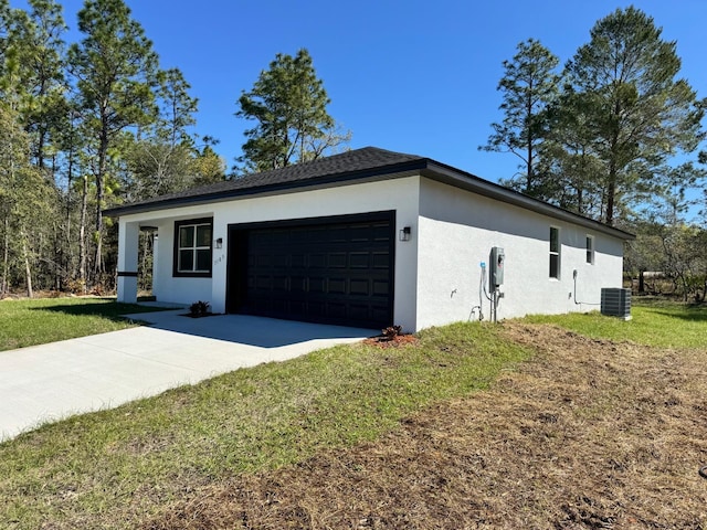 garage featuring central air condition unit and driveway
