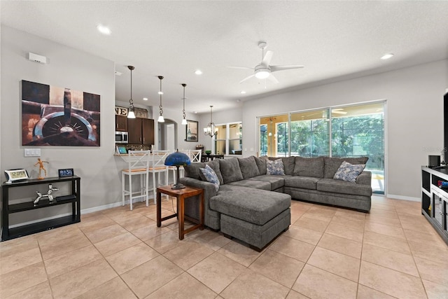 living area with light tile patterned flooring, ceiling fan, baseboards, and recessed lighting