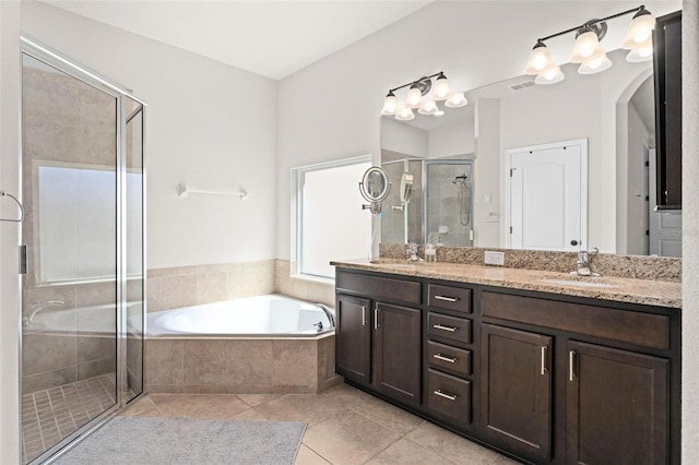 full bathroom with tile patterned floors, a sink, a shower stall, a bath, and double vanity