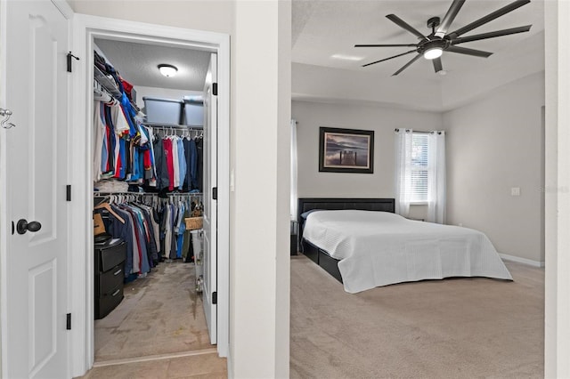 bedroom with a spacious closet, carpet, a closet, and a textured ceiling
