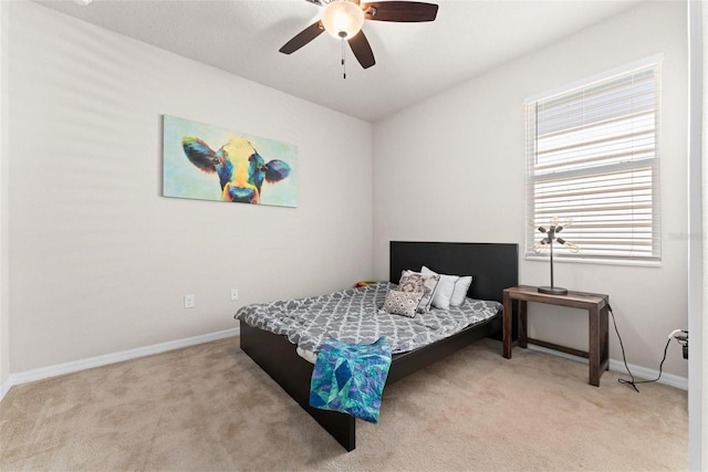 carpeted bedroom with baseboards and ceiling fan