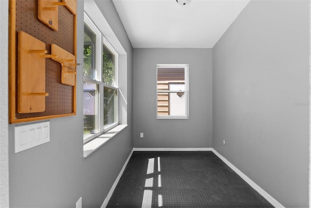 spare room featuring baseboards