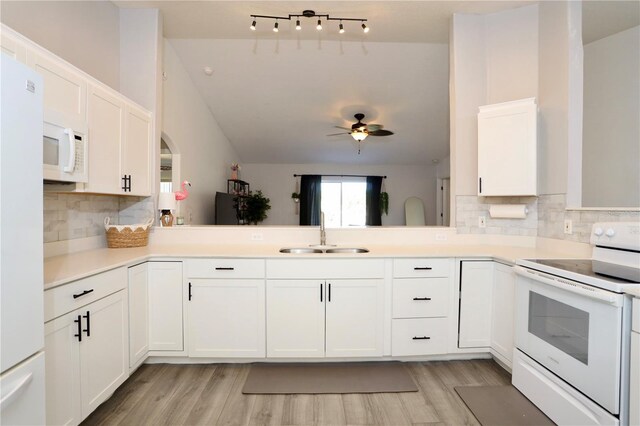 7 Sequoia Way, Kissimmee, FL 34758 - kitchen with white appliances, a sink, white cabinetry, backsplash, and light wood finished floors