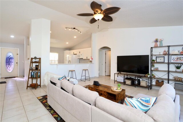 7 Sequoia Way, Kissimmee, FL 34758 - living room featuring light tile patterned floors, a ceiling fan, arched walkways, lofted ceiling, and recessed lighting
