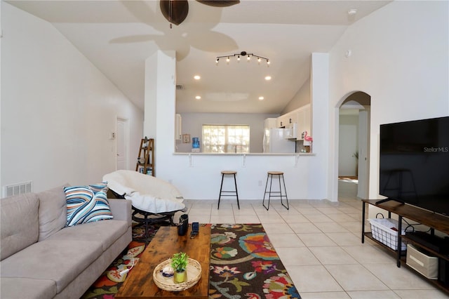 7 Sequoia Way, Kissimmee, FL 34758 - living area featuring vaulted ceiling, light tile patterned floors, arched walkways, ceiling fan, and recessed lighting