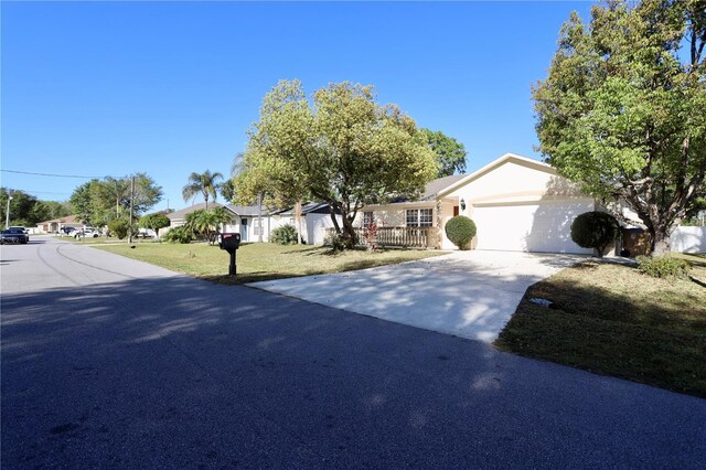 7 Sequoia Way, Kissimmee, FL 34758 - view of front of property with a garage, driveway, a front lawn, a residential view, and stucco siding