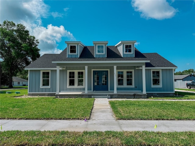 311 W Delaware Ave, Lake Helen, FL 32744 - bungalow-style house with covered porch, board and batten siding, and a front lawn