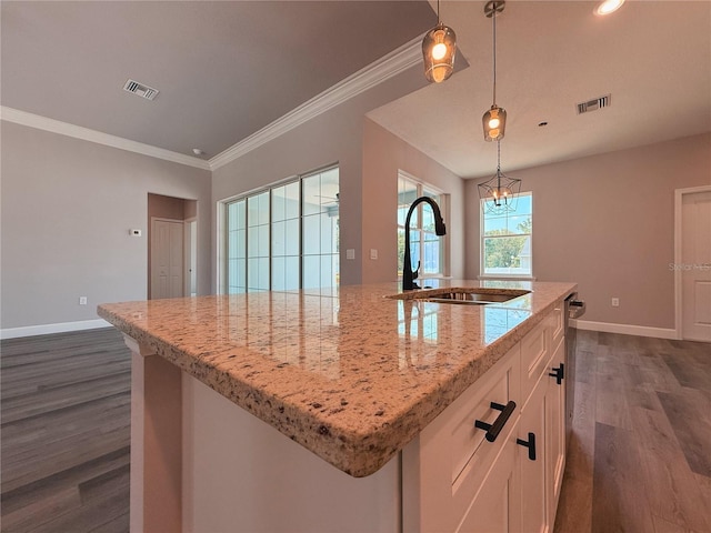311 W Delaware Ave, Lake Helen, FL 32744 - kitchen featuring a sink, dark wood-style floors, white cabinetry, baseboards, and light stone countertops