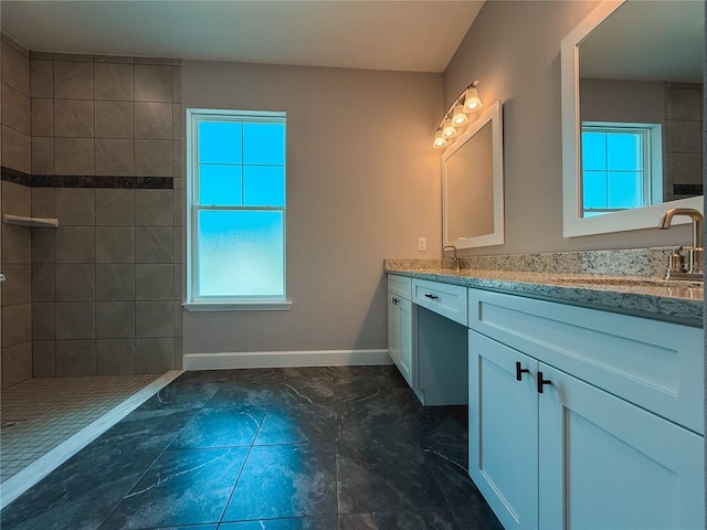 311 W Delaware Ave, Lake Helen, FL 32744 - bathroom with double vanity, baseboards, walk in shower, and marble finish floors