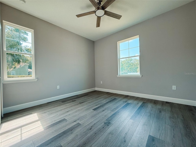 311 W Delaware Ave, Lake Helen, FL 32744 - spare room featuring plenty of natural light, a ceiling fan, dark wood finished floors, and baseboards