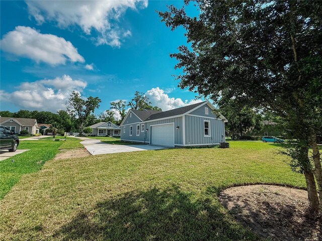 311 W Delaware Ave, Lake Helen, FL 32744 - view of grassy yard featuring concrete driveway and a garage