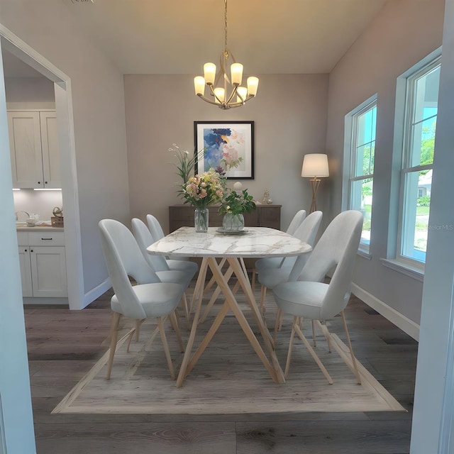 311 W Delaware Ave, Lake Helen, FL 32744 - dining room featuring baseboards, a chandelier, and wood finished floors