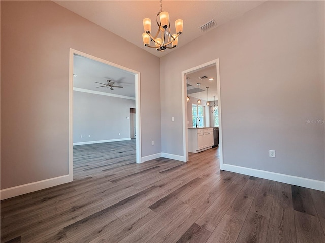 311 W Delaware Ave, Lake Helen, FL 32744 - unfurnished dining area with a chandelier, wood finished floors, baseboards, a ceiling fan, and a sink