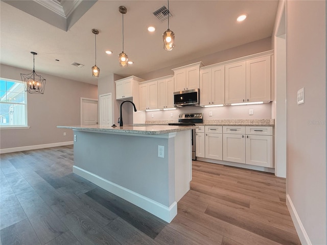 311 W Delaware Ave, Lake Helen, FL 32744 - kitchen featuring stainless steel appliances, baseboards, white cabinetry, and recessed lighting