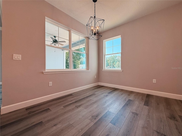 311 W Delaware Ave, Lake Helen, FL 32744 - spare room with a chandelier, dark wood-style floors, baseboards, and a ceiling fan