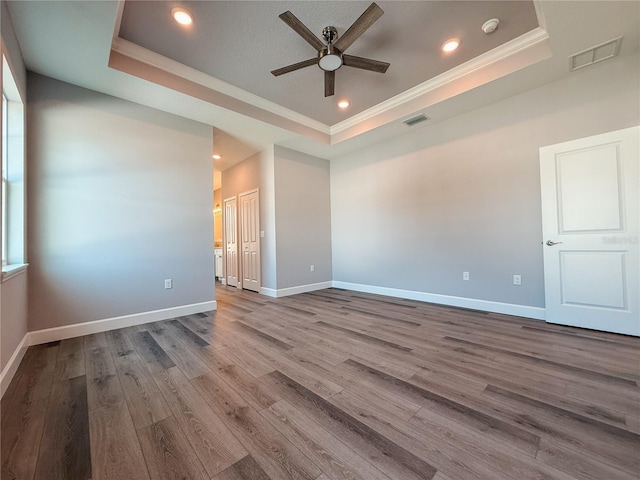 311 W Delaware Ave, Lake Helen, FL 32744 - empty room with a raised ceiling, ceiling fan, crown molding, wood finished floors, and baseboards