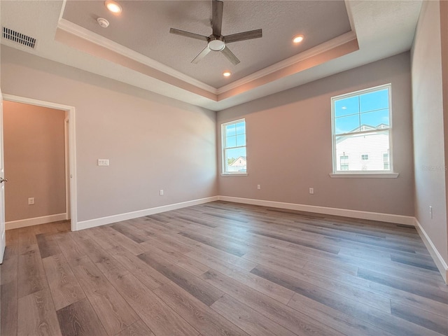 311 W Delaware Ave, Lake Helen, FL 32744 - empty room featuring a tray ceiling, ornamental molding, a ceiling fan, wood finished floors, and a smoke detector