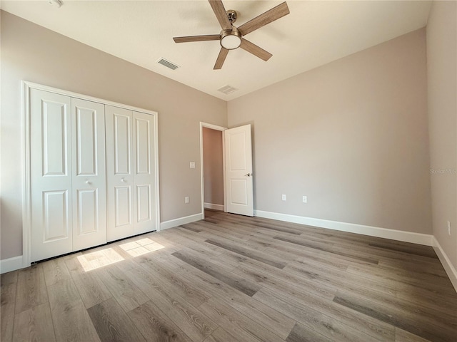 311 W Delaware Ave, Lake Helen, FL 32744 - unfurnished bedroom featuring light wood-type flooring, a closet, baseboards, and a ceiling fan