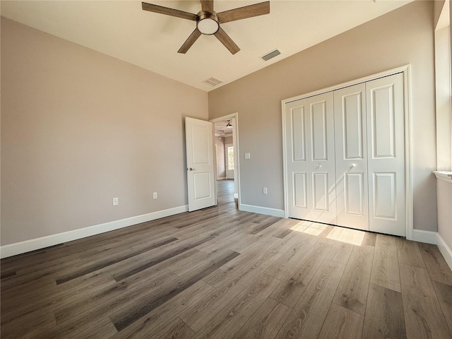 311 W Delaware Ave, Lake Helen, FL 32744 - unfurnished bedroom with wood finished floors, a closet, baseboards, and ceiling fan