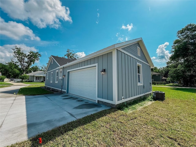 311 W Delaware Ave, Lake Helen, FL 32744 - view of side of property with board and batten siding, central air condition unit, an attached garage, concrete driveway, and a yard