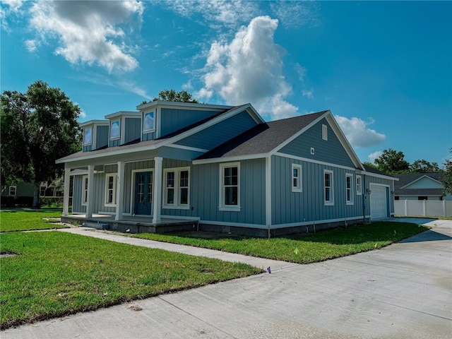311 W Delaware Ave, Lake Helen, FL 32744 - view of front of home with covered porch, board and batten siding, an attached garage, and driveway
