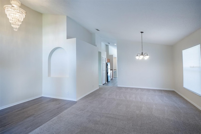 3199 Quail Dr, Deltona, FL 32738 - carpeted spare room with baseboards, lofted ceiling, visible vents, and a chandelier