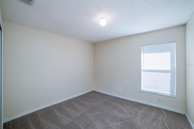 3199 Quail Dr, Deltona, FL 32738 - unfurnished room featuring baseboards, visible vents, dark colored carpet, and a textured ceiling