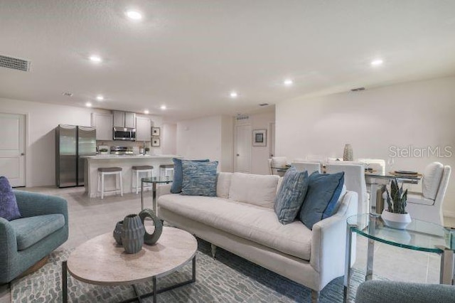 living area featuring recessed lighting and visible vents